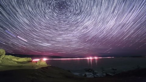 Starry night over the island Olkhon. Burkhan Cape, Olkhon island, Lake Baikal, Irkutsk region, Russia. Full HD
