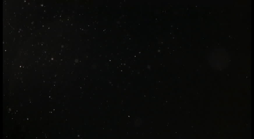 Snow falling outside. Near a street lamp in a residential area 