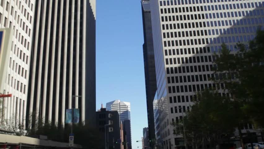 A view from below at the huge corporate office buildings that line the streets of downtown Houston Texas.
