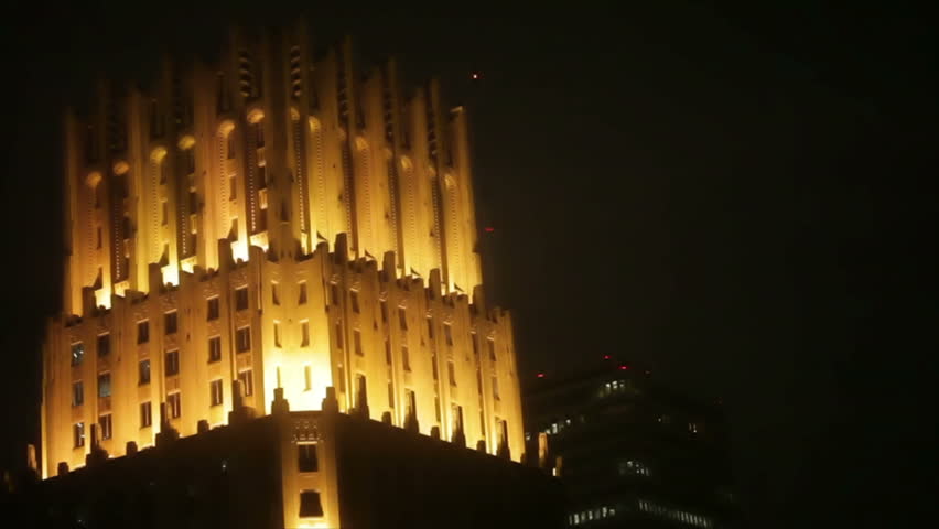 The brilliantly illuminated old Chase Bank building in downtown Houston Texas looms like a gothic castle in the night sky. 