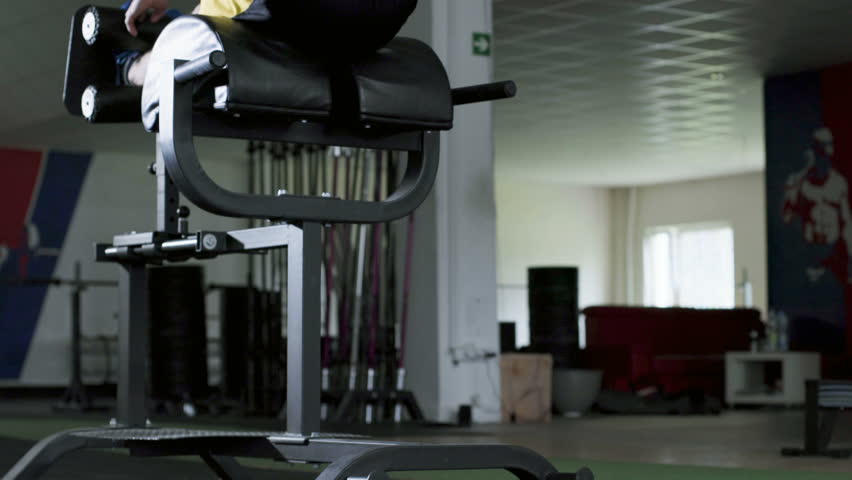 Closeup of athlete doing ghd sit ups at the gym