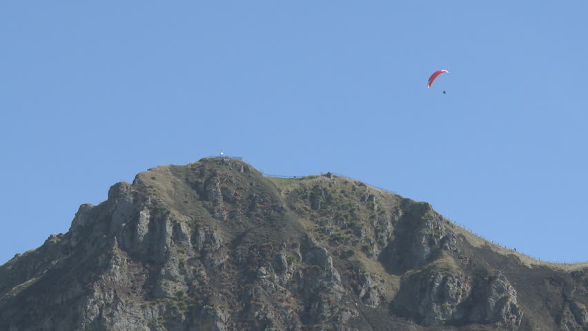 Para glider soars above a Peak