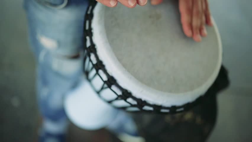 man playing the drums on the street