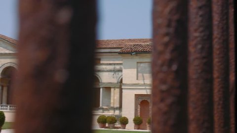 Mantua, Italy â?? 10 July 2016: Peek view of Palazzo Te in Mantua trough the gate bars