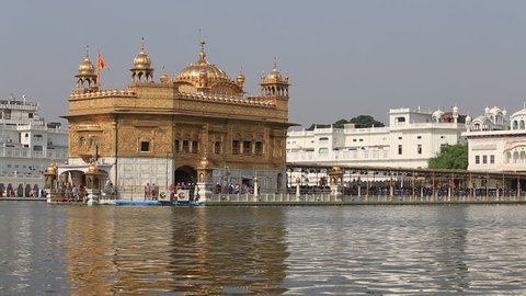 AMRITSAR, INDIA - SEPTEMBER 28, 2014: Unidentified Sikhs and indian people visiting the Golden Temple in Amritsar, Punjab, India. Sikh pilgrims travel from all over India to pray at this holy site