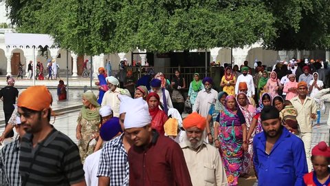 AMRITSAR, INDIA - SEPTEMBER 28, 2014: Unidentified Sikhs and indian people visiting the Golden Temple in Amritsar, Punjab, India. Sikh pilgrims travel from all over India to pray at this holy site