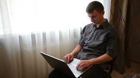 man playing on a laptop in the room