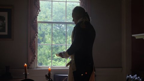 VIRGINIA - OCTOBER 2014 - Reenactment, Revolutionary War anniversary recreation, Presidents & George Washington -- Tabletop, quill writing, dipping ink and writing by candle light & by window. stands
