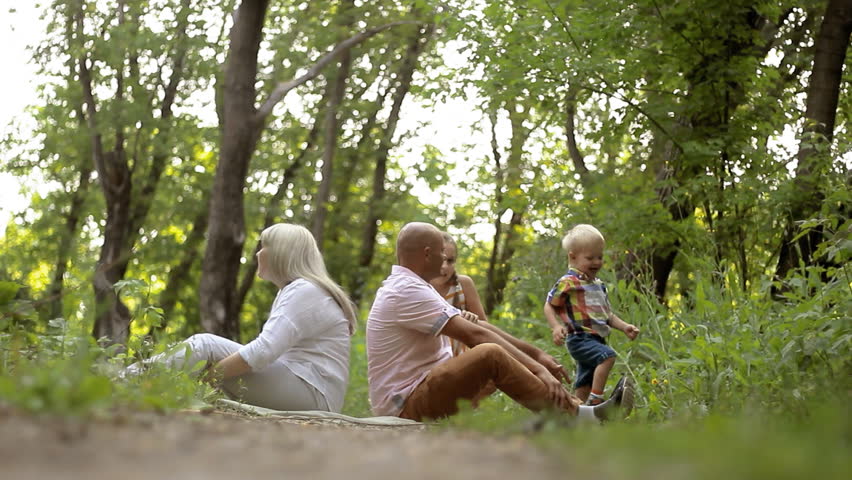 parents relax in the park with the children