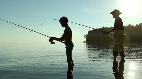 Father and son fishing on the lake.