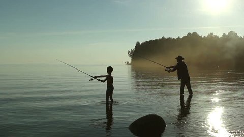 Father and son fishing on the lake.