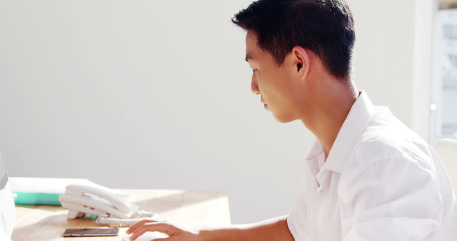 A man working on computer in a modern desk