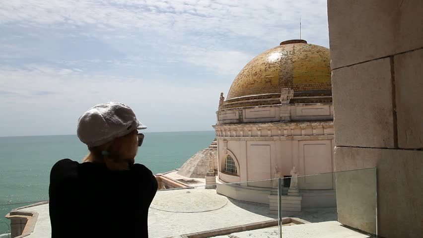 Woman looking the panorama of Cadiz town from the tower of Cathedral of Cadiz, Iglesia de Santa Cruz, Andalusia, Spain.