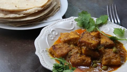 Plated Paneer butter masala with chapati or roti on the side