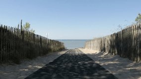 Path as natural border fence and pines to sea made of wooden planks 4K 3840X2160 UltraHD footage - Walkway near beach on Atlantic ocean 4K 2160p UHD tilting video
