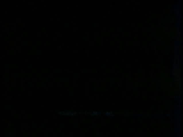 Wide shot people walking in road and cars driving on sidewalk