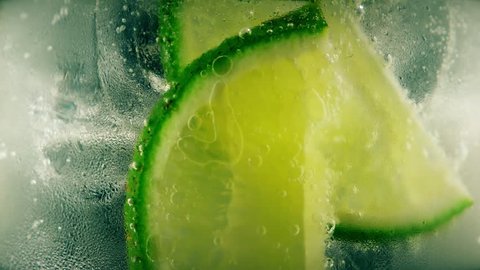 Cold cocktail with lime, tonic and ice, closeup