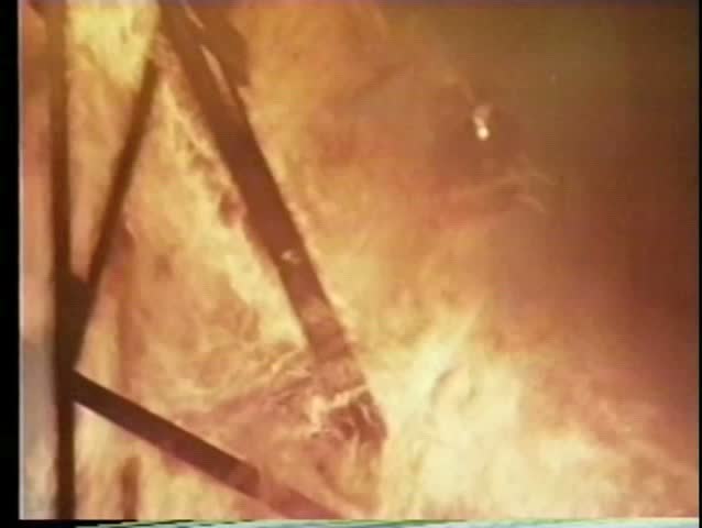 Spraying chemicals from helicopter to extinguish fire