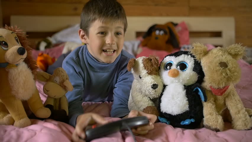 Young boy playing with a video game, game console, slow motion