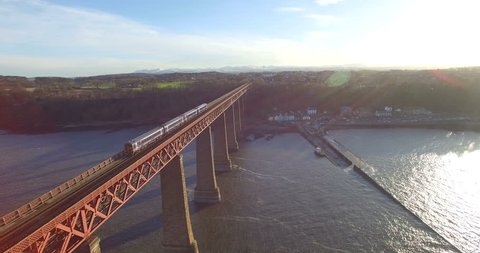 Aerial: Train on Forth Rail Bridge in Queensferry, Edinburgh, Scotland