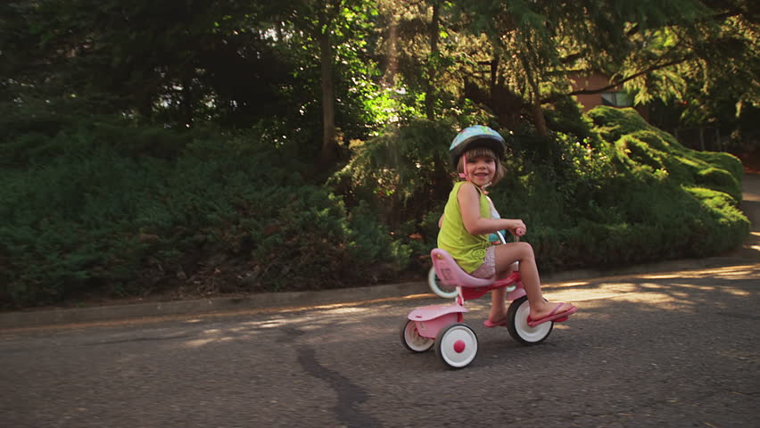 little girl on tricycle