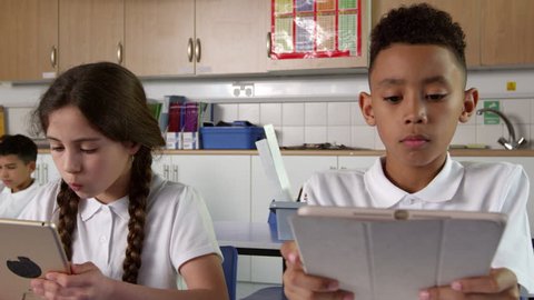 Pupils Sitting At Desks Using Digital Tablets Shot On R3D วิดีโอสต็อก