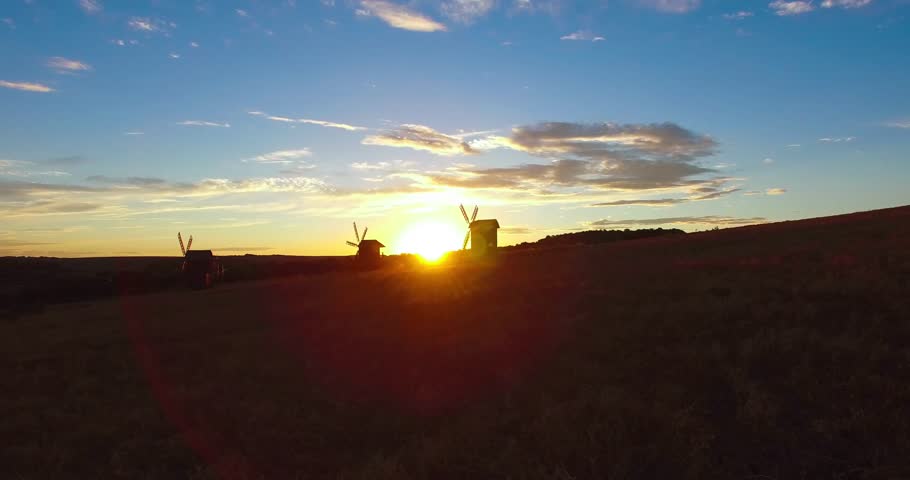 beautiful sunset in the field with a view of the mill.old mill