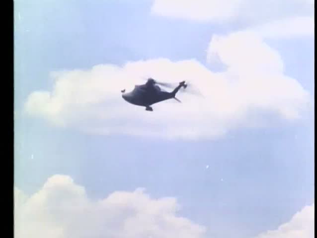 Helicopter dropping explosives on huts