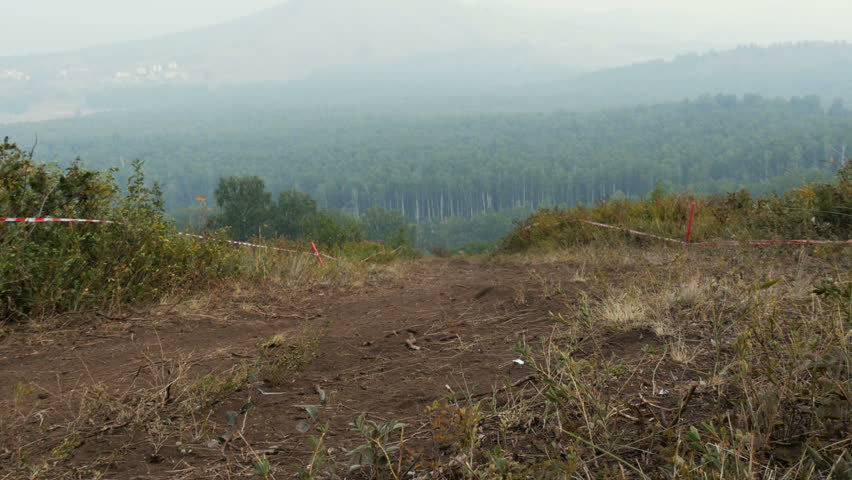 Extreme mountain bike sport athlete man riding dusty trail