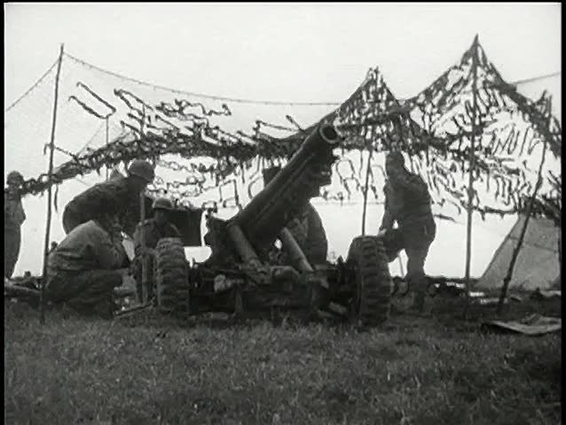 Wide shot soldiers firing cannon