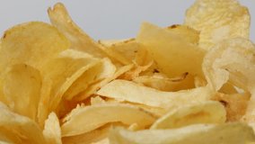 Potato chips tasty slices in a bowl popular snack slow tilt 4K 3840X2160 UltraHD footage - Deep fried salted crisps appetizer food background 2160p 30fps UHD tilting  video