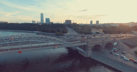 Aerial view of Luzhniki Metro Bridge, also known as Metromost, heavy traffic in the evening, Moscow river and city skyline during sunset. Big city life concept.    