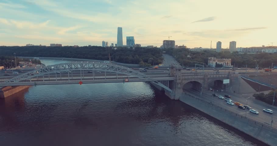 Aerial view of Luzhniki Metro Bridge, also known as Metromost, heavy traffic in the evening, Moscow river and city skyline during sunset. Big city life concept.     Royalty-Free Stock Footage #18308620