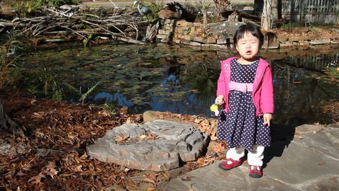 Beautiful Asian Baby Toddler Girl Playing by Side of Pond
