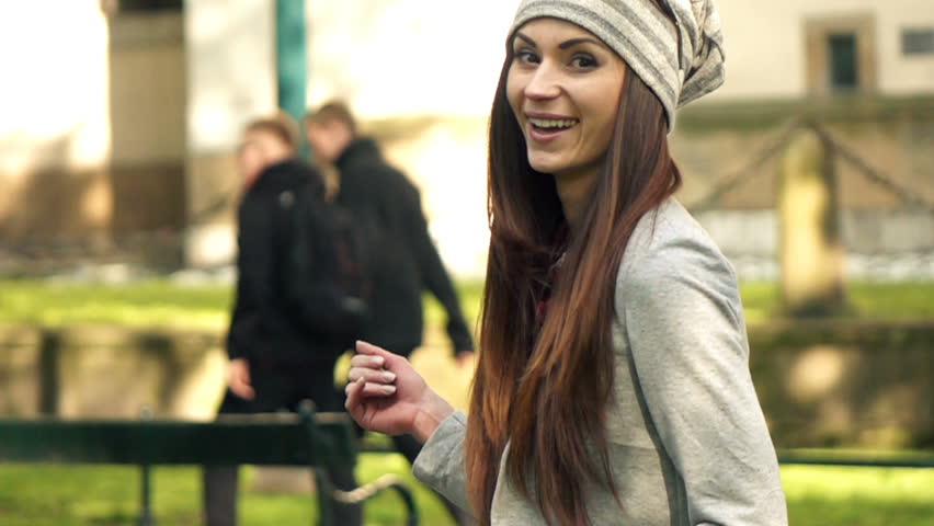 Portrait of happy, hipster woman walking in city park, super slow motion 240fps
