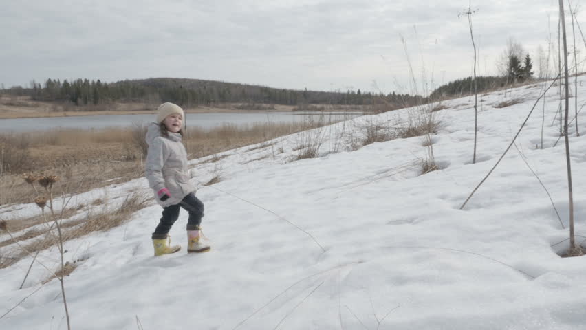 little girl walking on the field spring landscape