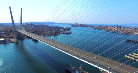 Great zooming in aerial view of the Zolotoy Bridge (the Golden Bridge) that is cable-stayed bridge across the Zolotoy Rog built in 2012 in Vladivostok, Russia, and cars driving on it.