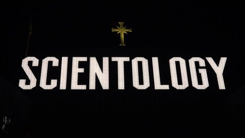 Los Angeles, CA- July 27, 2016: Scientology giant sign is displayed on top of the blue headquarters building. The sign overshadows where hundreds of Scientologists can be seen frequenting the area.   