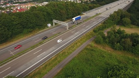 Niedernhausen, Germany - July 27, 2016: German LKW-Maut, electronic toll control gantry at highway A3 between Niedernhausen and Idstein, Hesse. Passing trucks and cars.