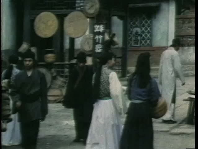 Wide shot Asian people walking through town
