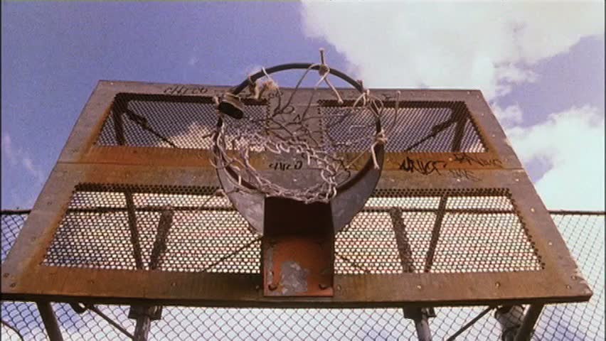 Low angle view basketball going into hoop