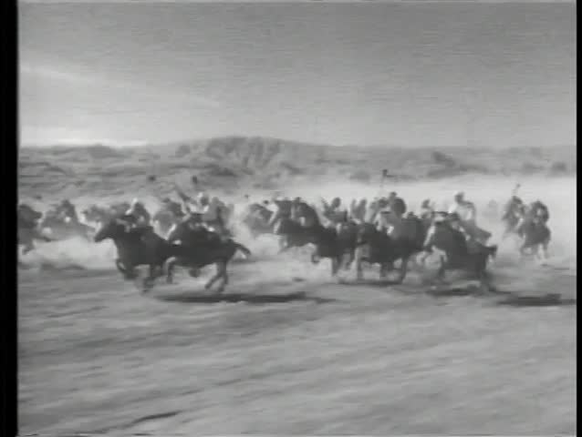 Moroccan cavalry charging through desert