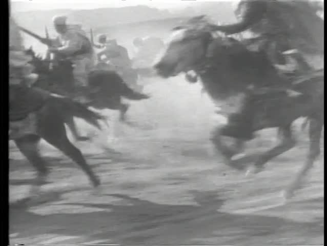 Moroccan cavalry charging through desert