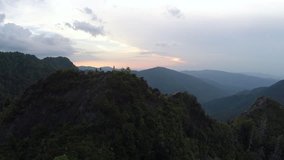 Aerial footage - hiking  a cliff on top of mountain in Smoky Mountains in sunset flyover