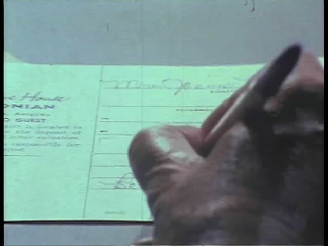 Close-up of hand signing name