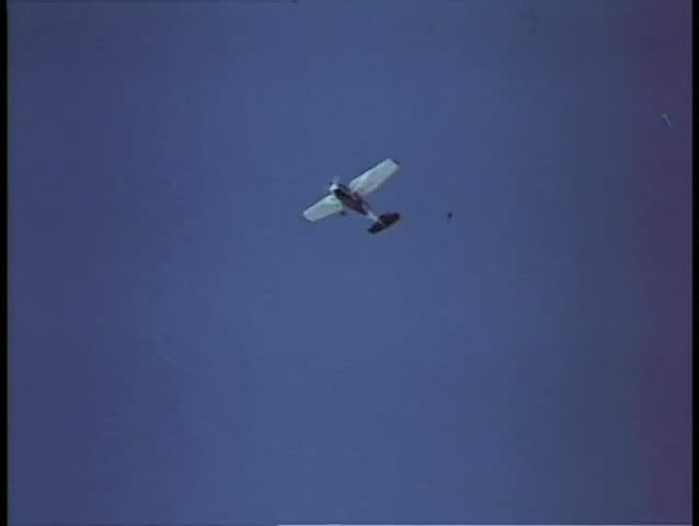 Person parachuting out of airplane