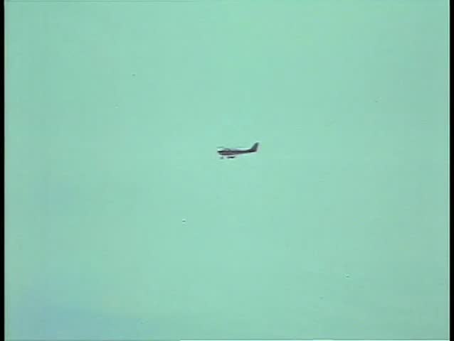 Long shot of a small airplane in flight