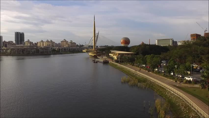 Aerial footage of a public park by the lakeside located in Putrajaya, Malaysia.
