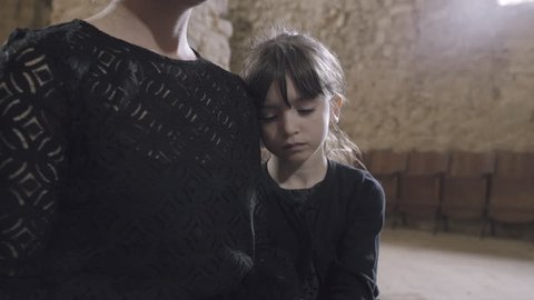 Mother with child at a funeral