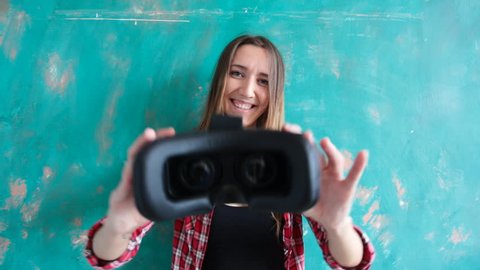 Young woman giving virtual reality headset